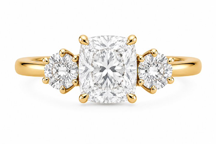 Adelaide 14K yellow gold three-stone engagement ring with a cushion center and round lab grown side diamonds.