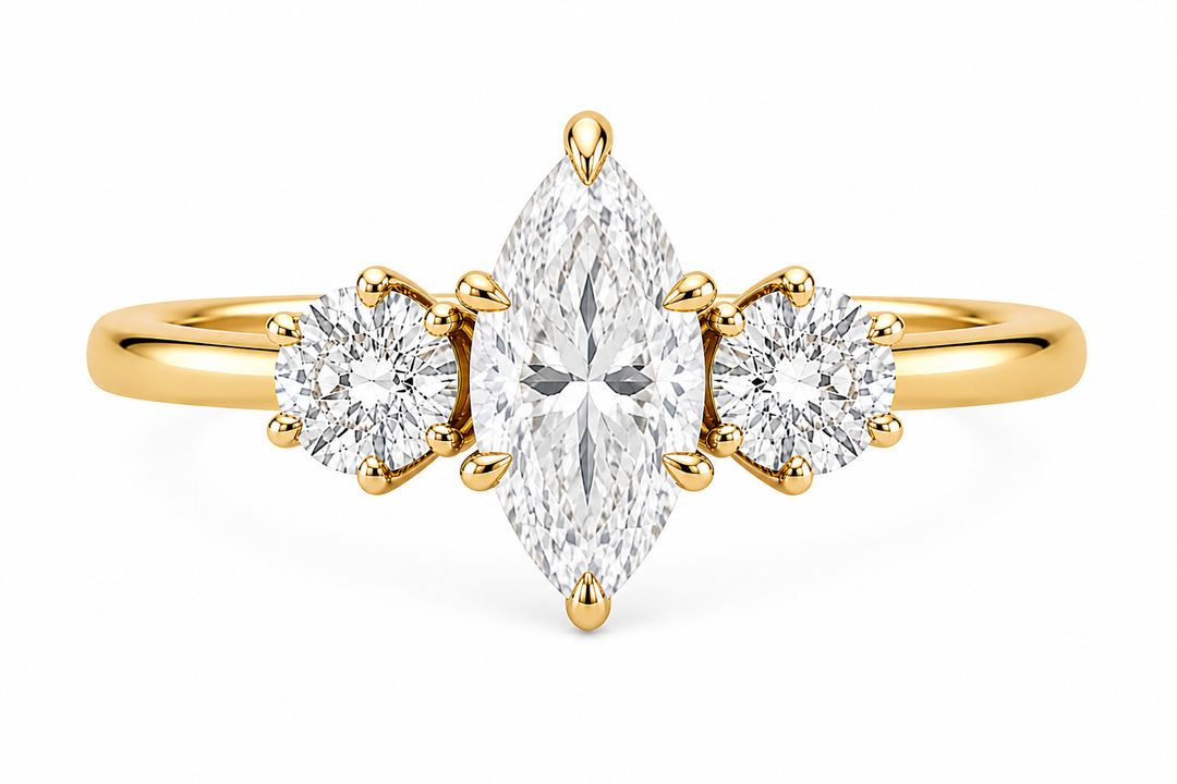Adelaide 14K yellow gold engagement ring with a marquise center diamond and two round side stones.