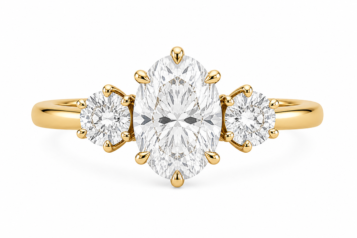 Adelaide three-stone engagement ring with oval center diamond, round side stones, and 14K yellow gold band.