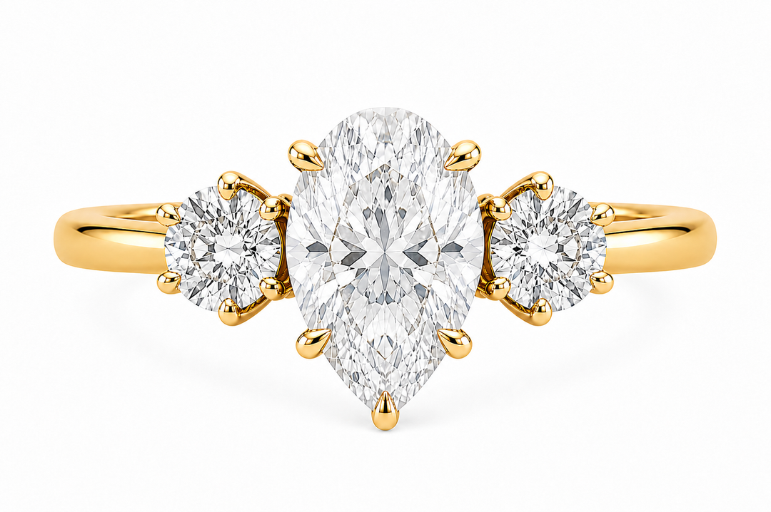 Adelaide 14K yellow gold engagement ring with a pear-shaped center diamond and two round side diamonds.