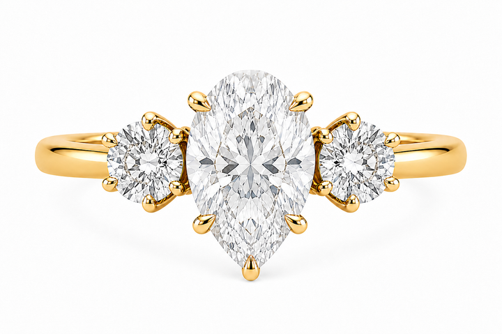 Adelaide 14K yellow gold engagement ring with a pear-shaped center diamond and two round side diamonds.