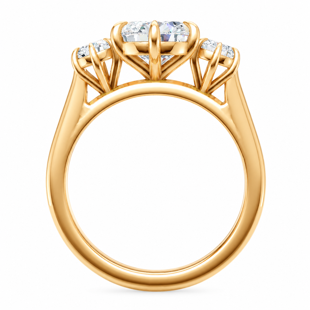 Adelaide three-stone engagement ring in 14K yellow gold with a large center diamond and two round side diamonds.