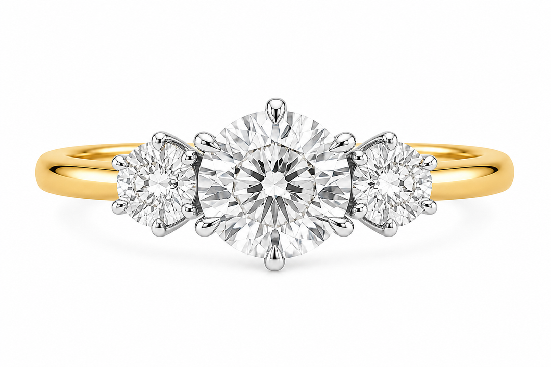 Adelaide 14K yellow gold three-stone engagement ring with a large round center diamond and two smaller round side diamonds.