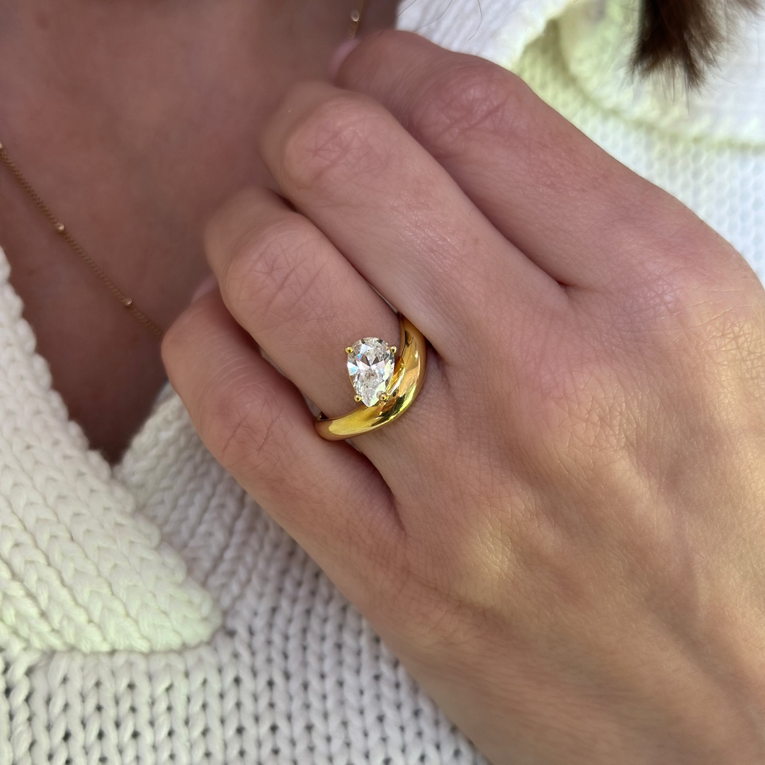 Caroline Signature Engagement Style: 14K yellow gold ring with a sculptural curve and pear-shaped diamond.