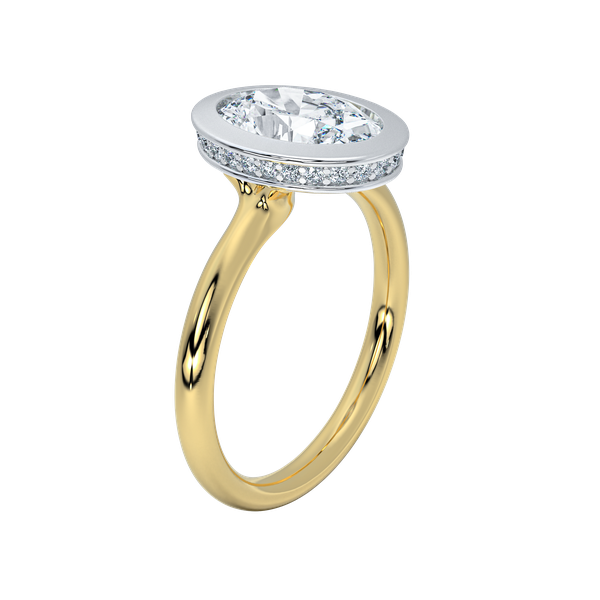 Celeste two-tone engagement ring with a white gold bezel-set oval diamond and yellow gold band.