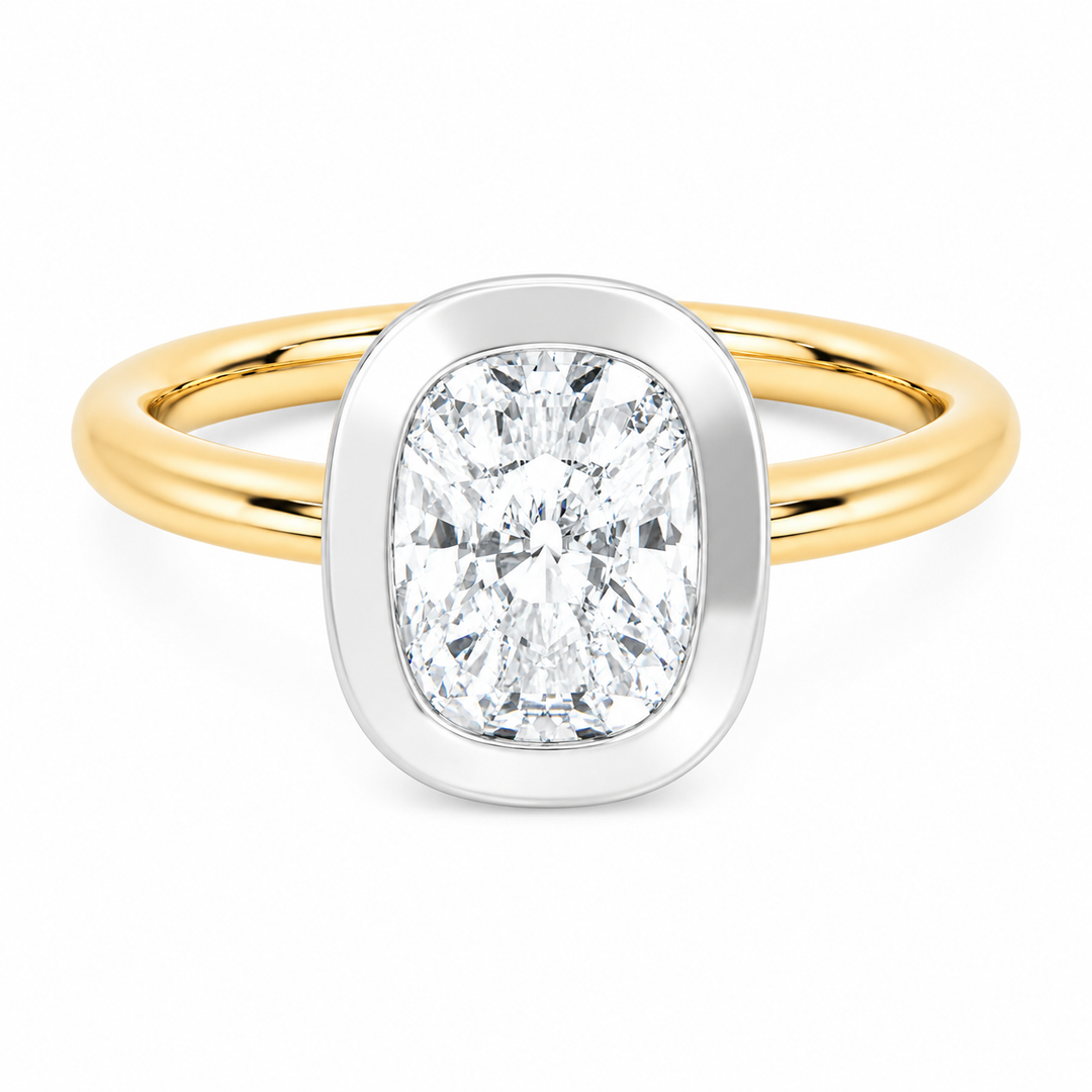 Celeste two-tone 14K yellow and white gold bezel engagement ring with cushion diamond.