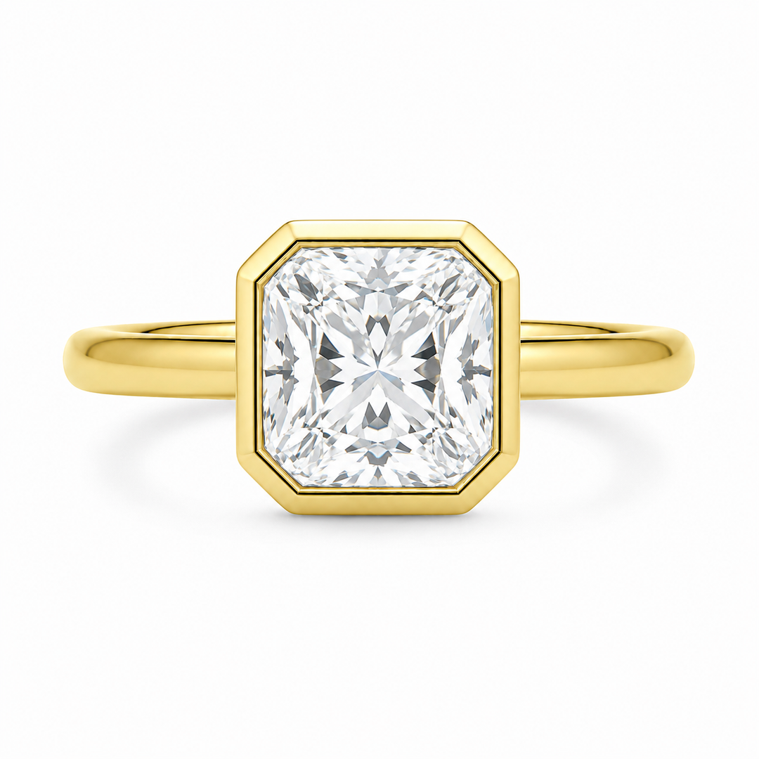 Celine 14K yellow gold engagement ring with a modern bezel-set cushion diamond.