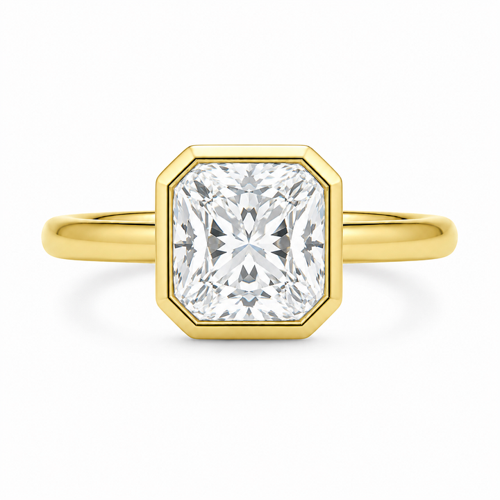 Celine 14K yellow gold engagement ring with a modern bezel-set cushion diamond.