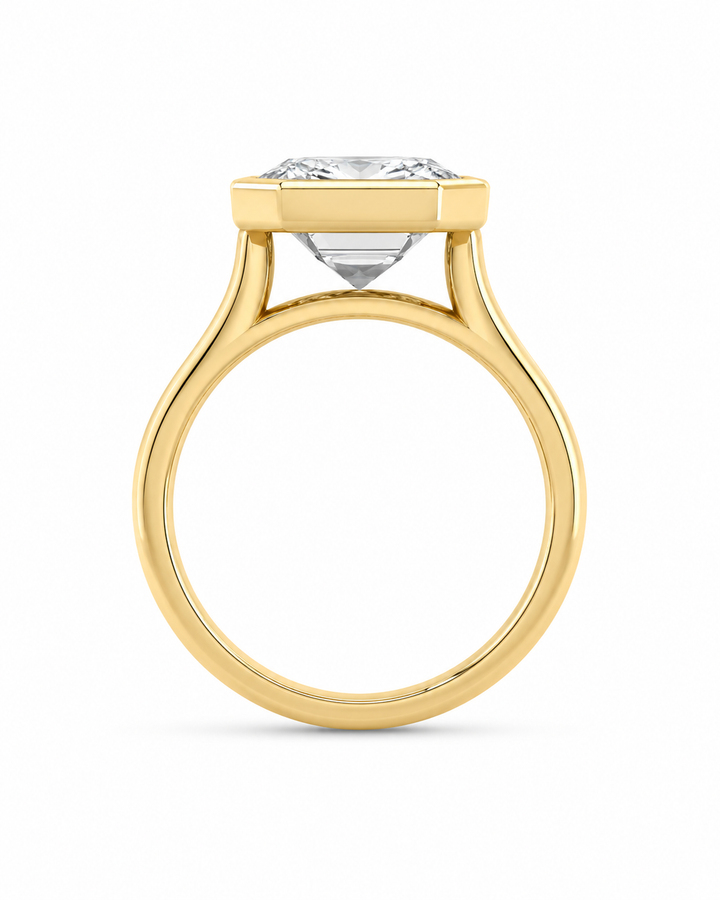 Celine 14K yellow gold engagement ring with a modern bezel-set solitaire diamond.