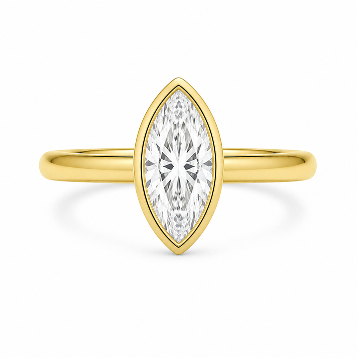 Celine 14K yellow gold engagement ring with a bezel-set marquise diamond.
