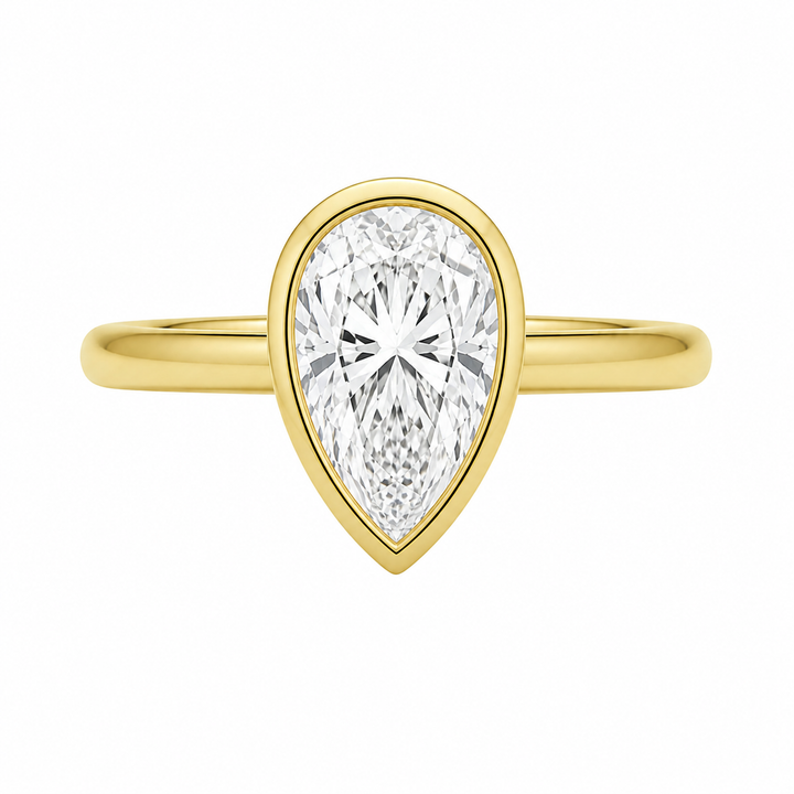 Celine 14K yellow gold engagement ring with a pear-shaped bezel-set diamond.