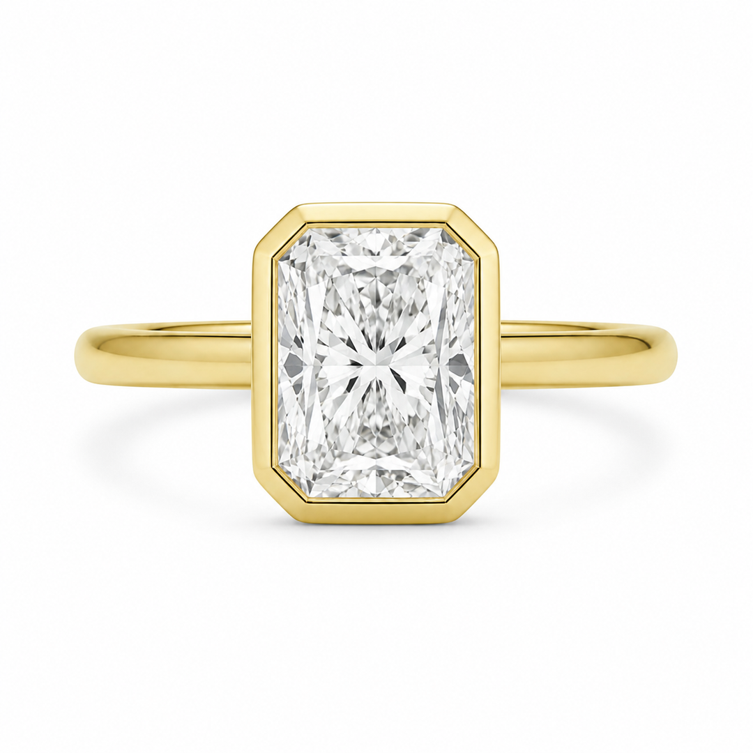 Celine 14K yellow gold engagement ring with a radiant bezel-set diamond.