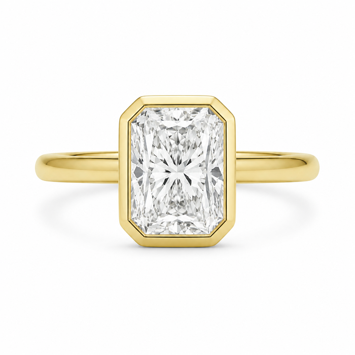 Celine 14K yellow gold engagement ring with a radiant bezel-set diamond.