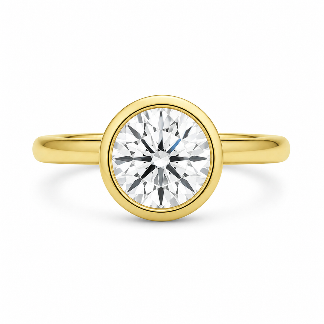 Celine 14K yellow gold engagement ring with a modern bezel-set round diamond.