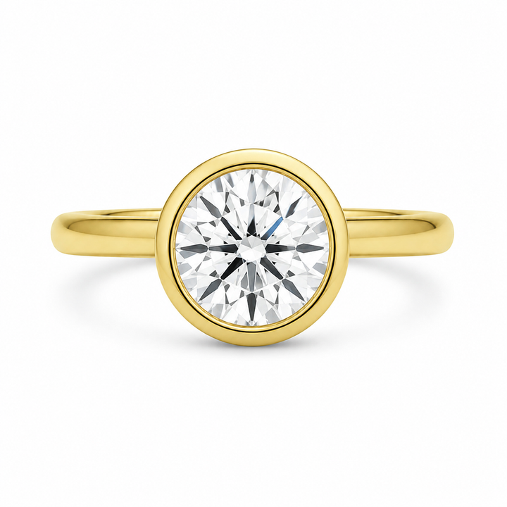Celine 14K yellow gold engagement ring with a modern bezel-set round diamond.