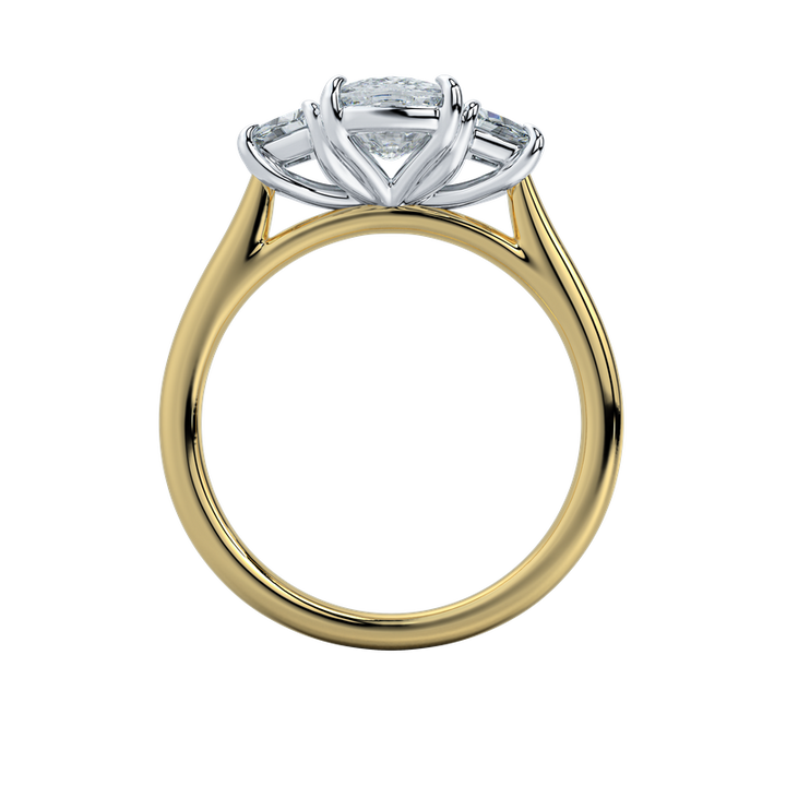 Charlotte engagement ring with a gold band, emerald cut center stone, and trapezoid side stones.