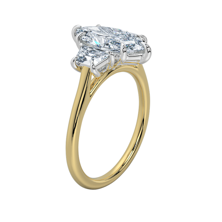Charlotte engagement ring with an emerald center stone and trapezoid side stones on a yellow gold band.