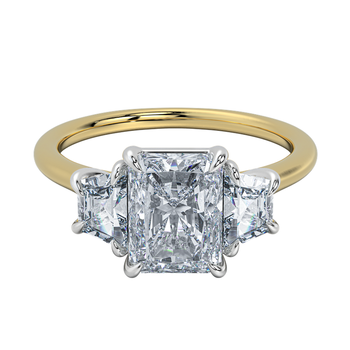 Charlotte engagement ring with radiant center diamond and trapezoid side stones on a yellow gold band.