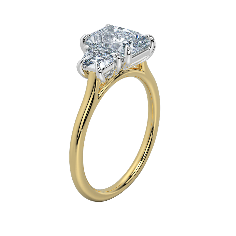 Charlotte engagement ring: gold band, emerald cut center stone, trapezoid side stones.