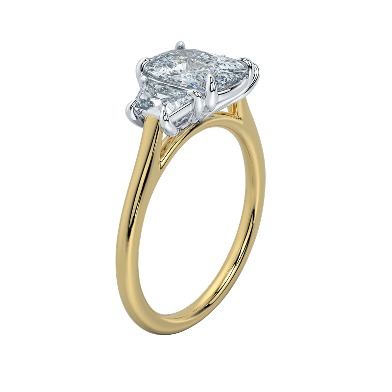Gold engagement ring with emerald cut center diamond and trapezoid side stones.