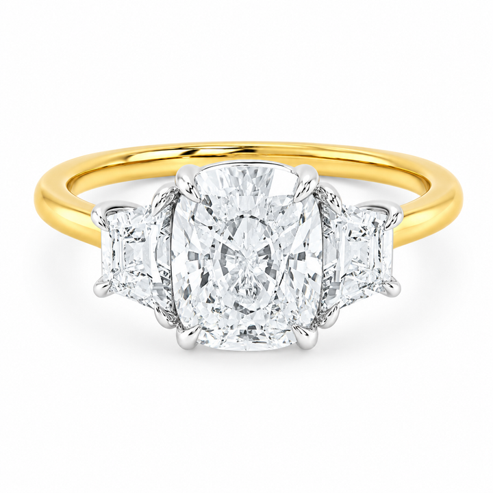Charlotte three-stone engagement ring with a cushion diamond, trapezoid side stones, and a yellow and white gold setting.