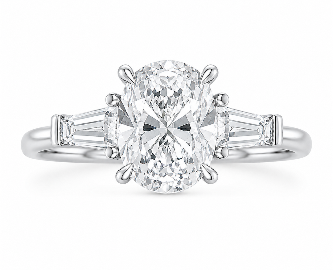 Colette 14K white gold engagement ring with an oval center diamond and tapered baguette side stones.