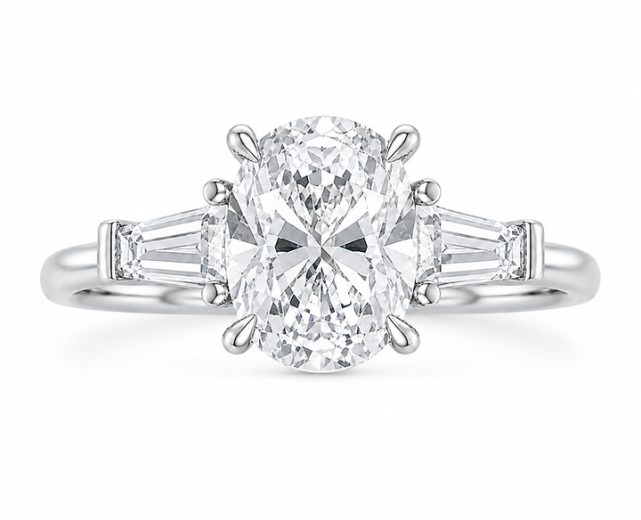 Colette 14K white gold engagement ring with an oval center diamond and tapered baguette side stones.
