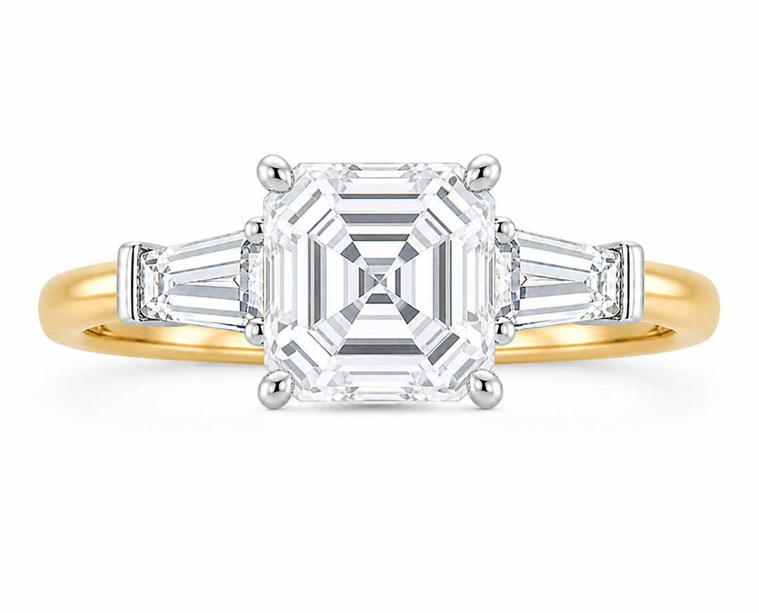 Colette Signature three-stone engagement ring with an Asscher diamond and tapered baguette side stones on a two-tone 14K yellow gold band.