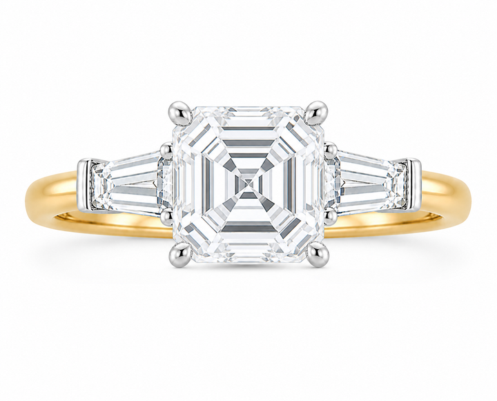Colette Signature three-stone engagement ring with an Asscher diamond and tapered baguette side stones on a two-tone 14K yellow gold band.