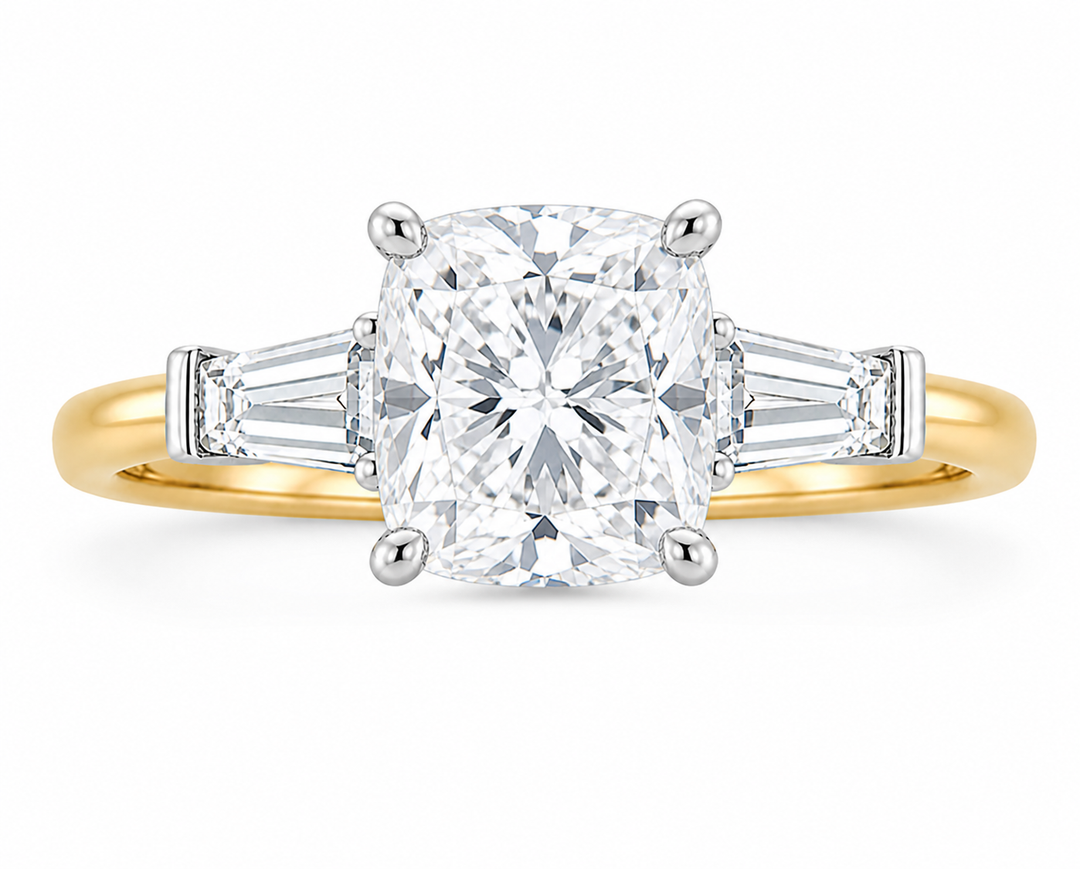 Colette 14K yellow gold engagement ring with a cushion-cut diamond and tapered baguette side stones.
