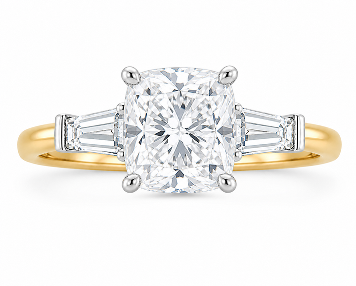 Colette 14K yellow gold engagement ring with a cushion-cut diamond and tapered baguette side stones.