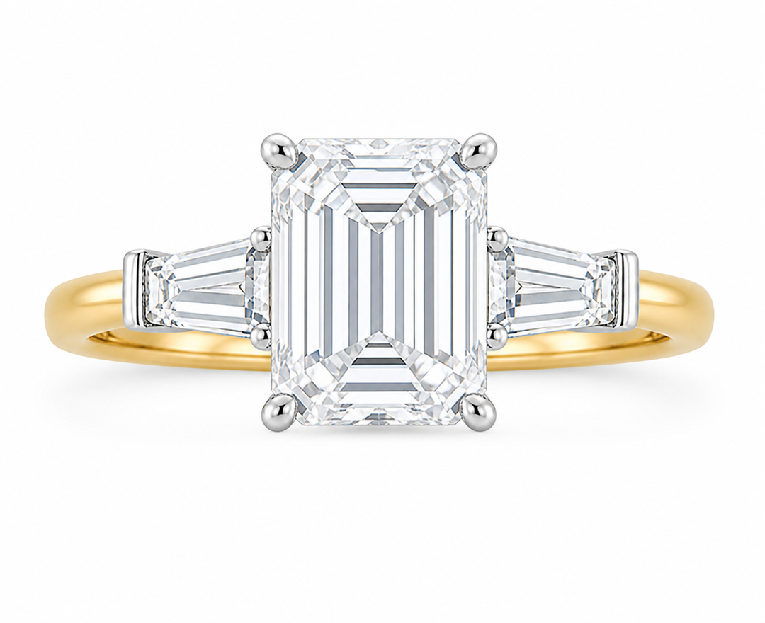 Colette engagement ring: 14K yellow gold band, white gold setting, emerald cut center diamond, tapered baguette side stones.