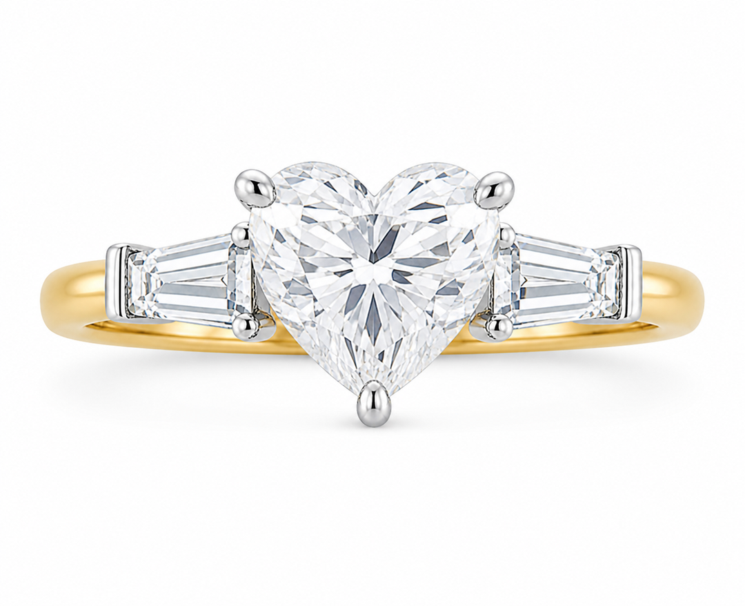 Colette Signature engagement ring with a heart-shaped diamond, tapered baguette side stones, and a two-tone 14K yellow and white gold band.