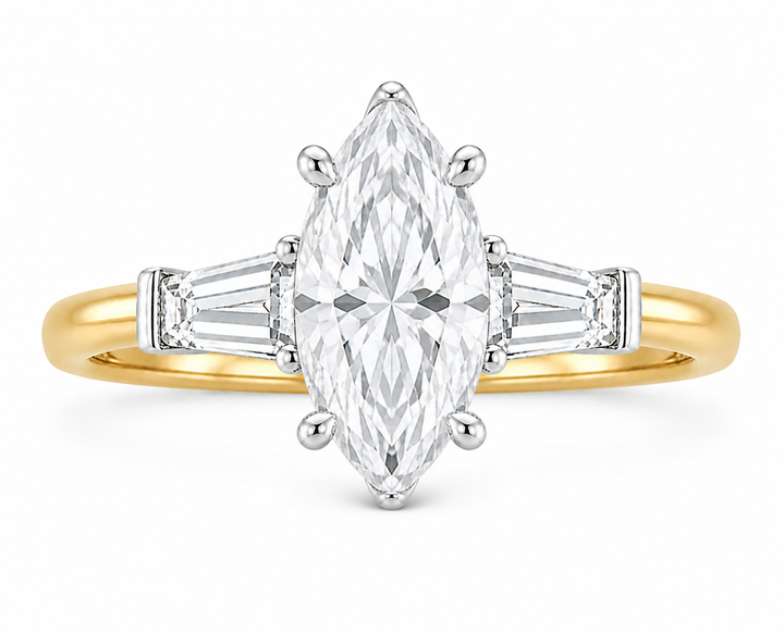Colette Signature engagement ring with a marquise diamond, tapered baguette side stones, and a two-tone 14K yellow gold band.