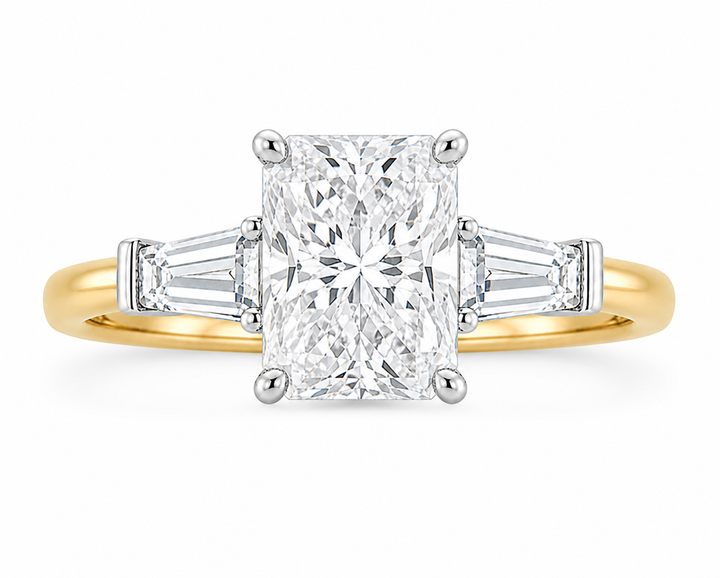 Colette Signature Engagement Style: Radiant cut diamond with tapered baguette side stones on a two-tone 14K gold band.