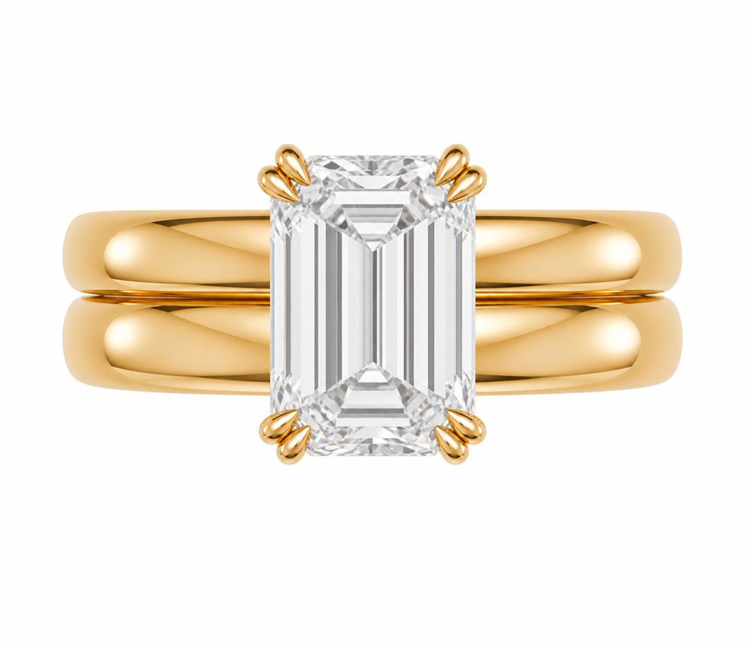 Frankie Signature engagement ring with an emerald cut diamond on a 14K yellow gold double dome band.