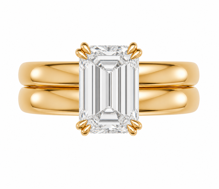 Frankie Signature engagement ring with an emerald cut diamond on a 14K yellow gold double dome band.