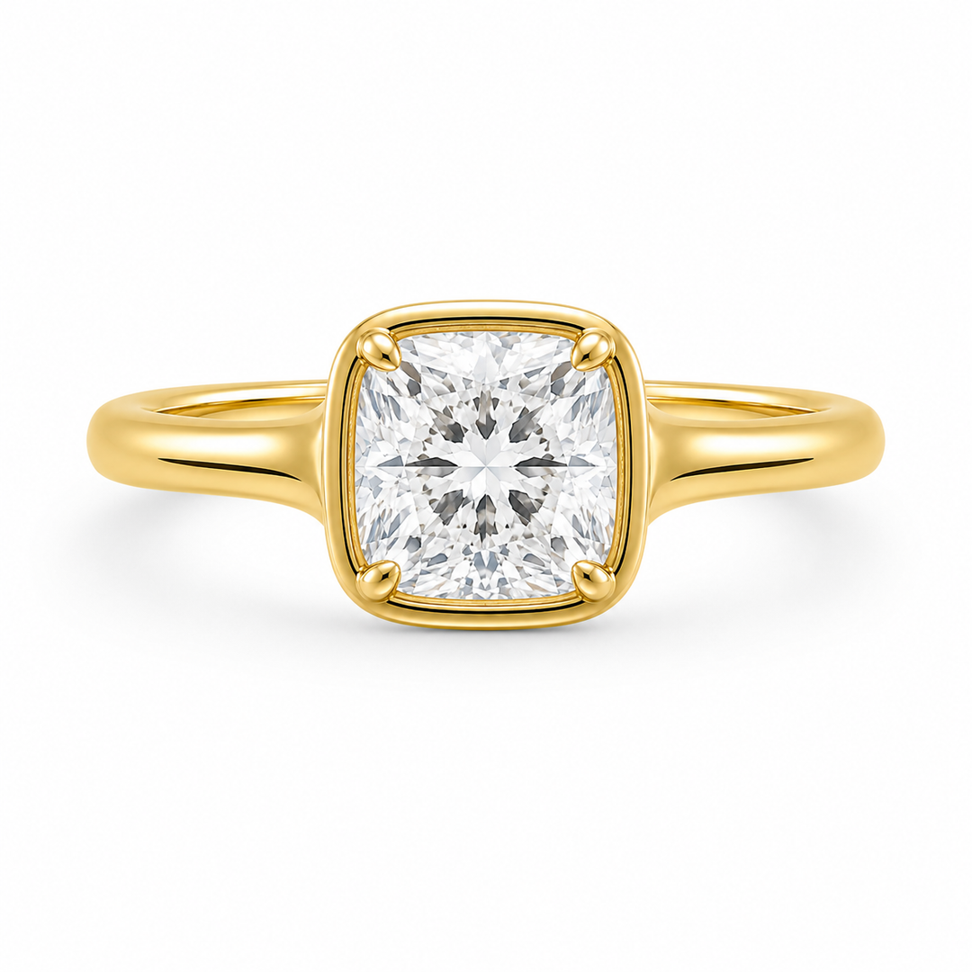 Goldie Signature Engagement Style: 14K yellow gold ring with a cushion-cut diamond in a dome-like bezel setting.