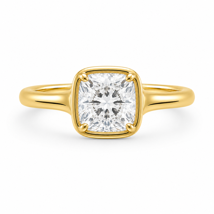 Goldie Signature Engagement Style: 14K yellow gold ring with a cushion-cut diamond in a dome-like bezel setting.