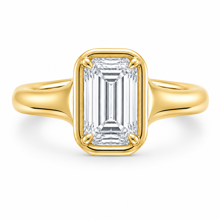 Goldie Signature 14K yellow gold engagement ring with a bezel-set emerald cut diamond.