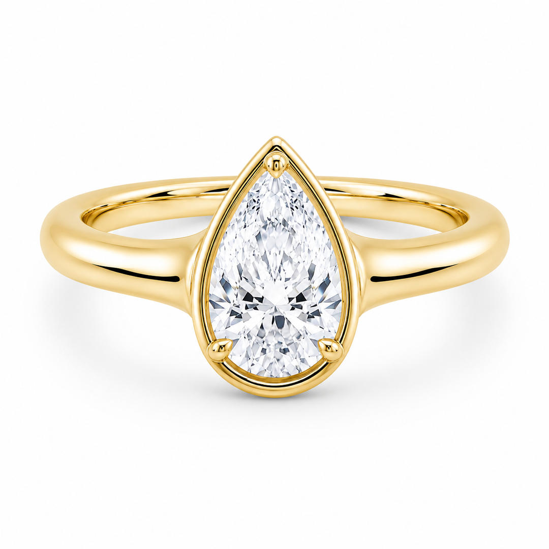 Goldie Signature 14K yellow gold engagement ring with a pear-shaped diamond and claw prongs.