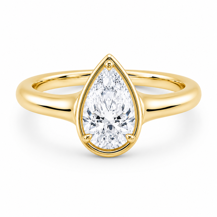 Goldie Signature 14K yellow gold engagement ring with a pear-shaped diamond and claw prongs.