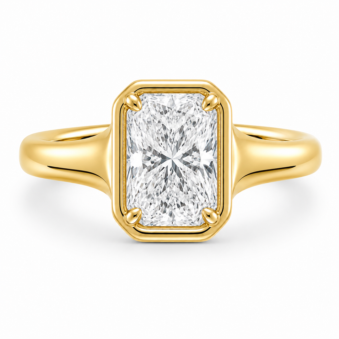 Goldie Signature Engagement Style: 14K yellow gold ring with a radiant cut diamond in a dome-like bezel setting.