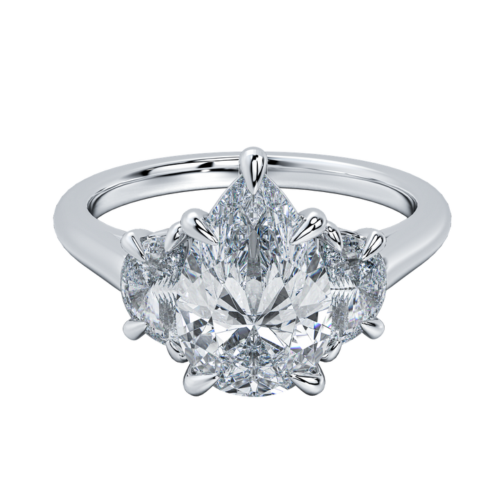 Hailey engagement ring with a large pear-cut diamond flanked by two smaller pear-cut diamonds on a delicate gold band.