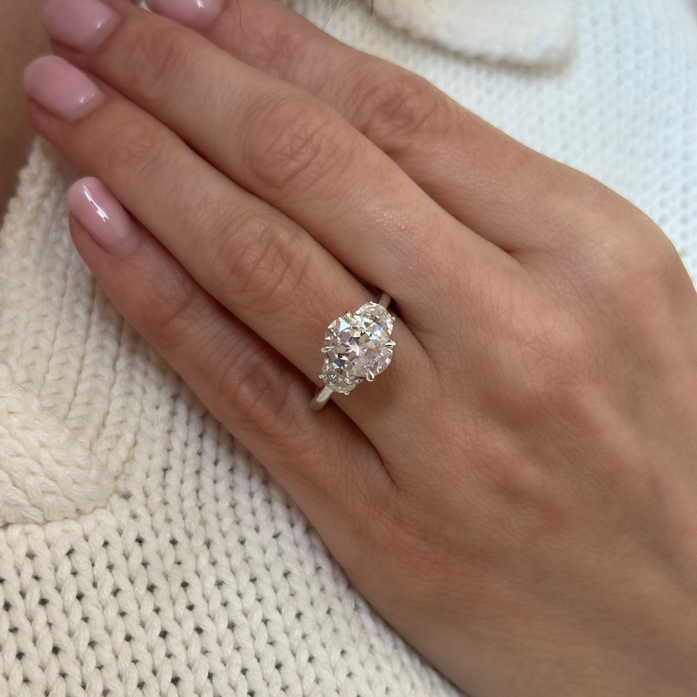 Hailey Signature 14K white gold engagement ring with a 2 CT oval diamond and half moon side stones.