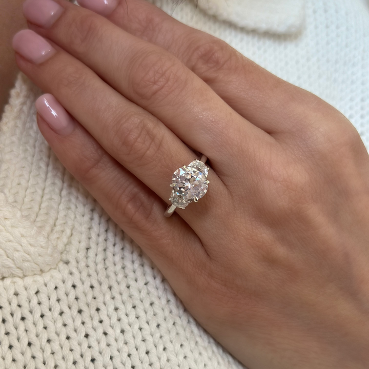 Hailey Signature 14K white gold engagement ring with a 2 CT oval diamond and half moon side stones.