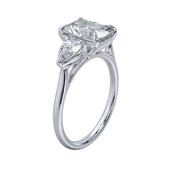 Silver three-stone engagement ring with a radiant cut center diamond and two pear-shaped side stones.