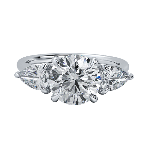 Silver three-stone engagement ring with a round center diamond flanked by two pear-shaped diamonds.