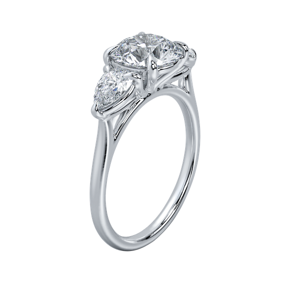 Silver three-stone engagement ring with a round center diamond and two pear-shaped side diamonds.