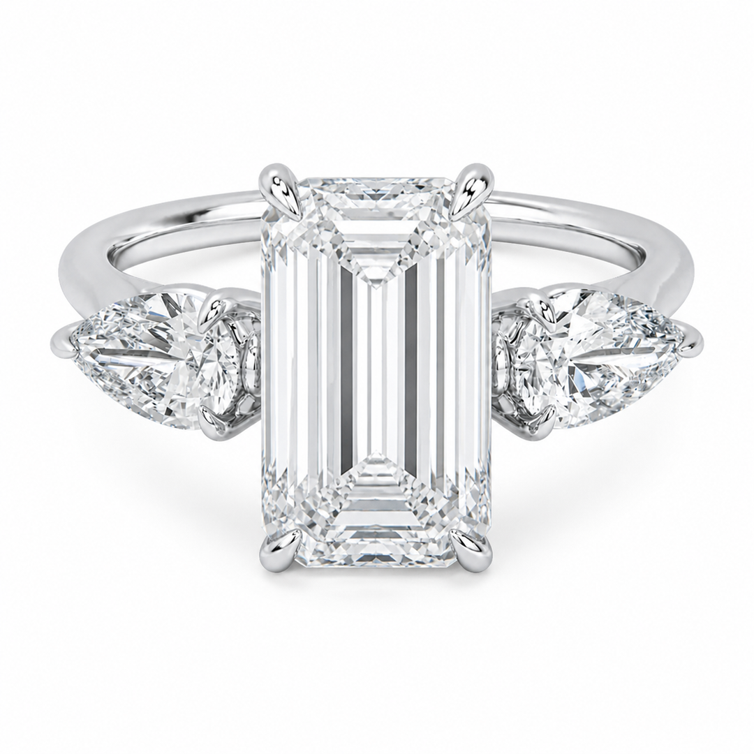 Ivy Signature 14K white gold engagement ring with emerald cut center and pear side diamonds.